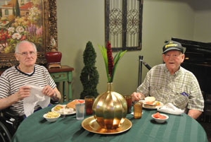 elderly men eating together